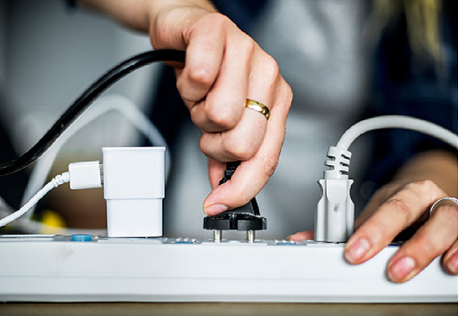 hand holding a plug